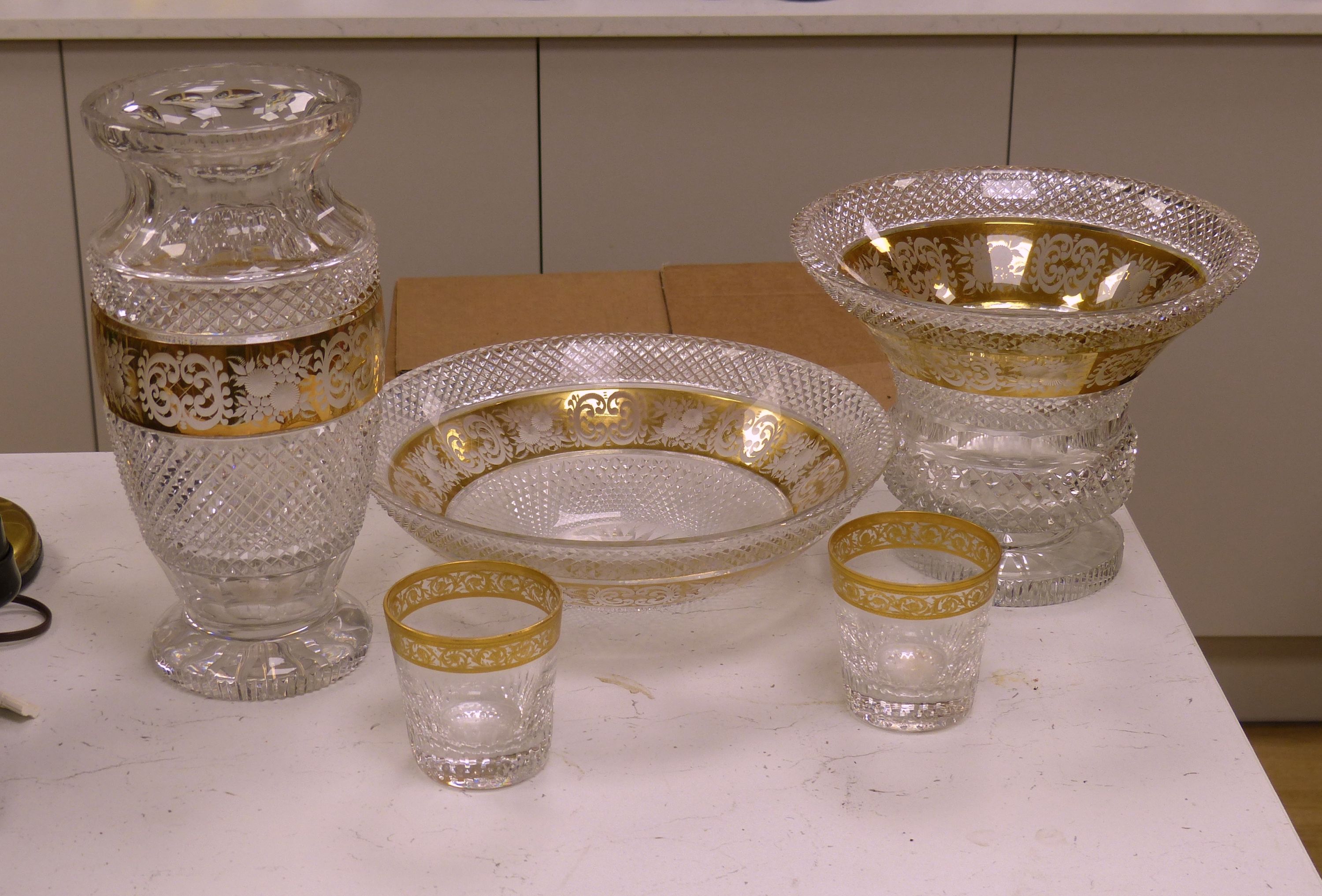 A Moser style tall tapered cut glass vase heightened in gilt, a similar circular bowl, a pedestal bowl and two St Louis tumblers
